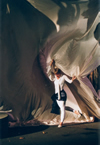 Dancer pulling a large swath of fabric behind her