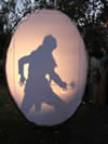 Shadow of a person backlit on an oval screen