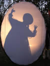 Shadow of another person backlit onto an oval screen