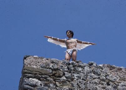 Dancer with wing costume atop a castle tower